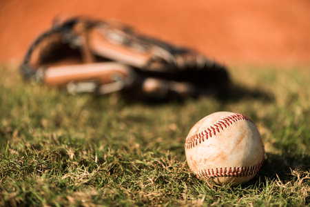 Baseball Mitt Glove with Ball on field. Close up