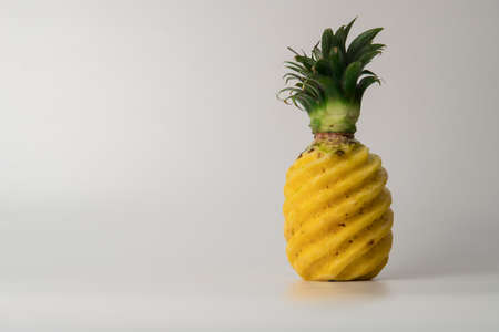 Green yellow pineapple isolated in white background.の写真素材