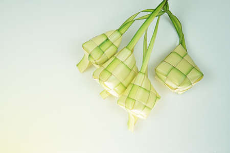 Ketupat or rice dumpling a famous main course during the festive season.Ketupat's, a rice casing made from young coconut leaves for cooking rice on a white background.の写真素材