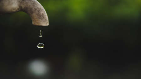 Tap water drop close up outdoor.の写真素材
