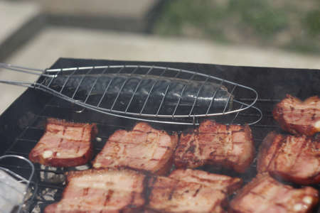 Barbecuing meat on charcoal fire closeup image.の写真素材