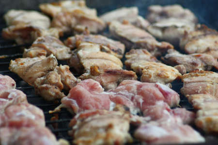 Barbecuing meat on charcoal fire closeup image.の写真素材