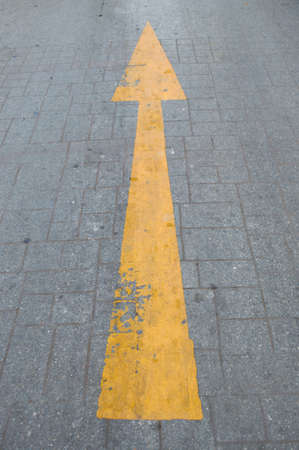 Yellow arrow on the road, Traffic to go straightの写真素材