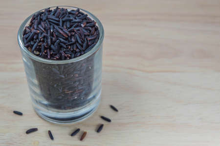 Rice berry isolated on wooden boardの写真素材