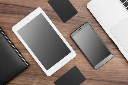 Desk with tablet, smartphone and laptop