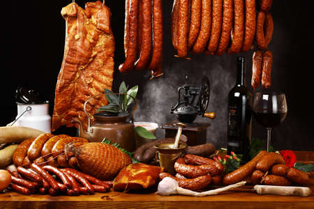 Many kinds of meat and kitchen accessories on black backgroundの写真素材