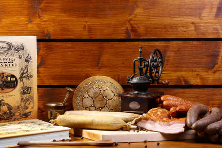 Table with meat, cookbook and kitchenwareの写真素材