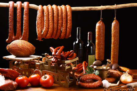 Country table with meat and wine on black backgroundの写真素材