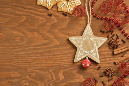 Christmas gingerbread on wooden background with various decoration and spices