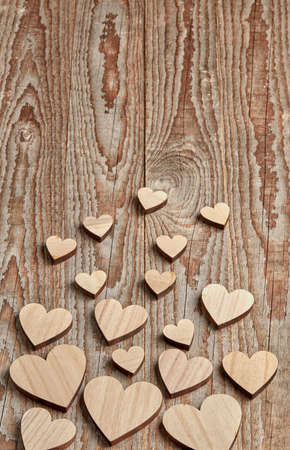 Different size heart figures on wooden backgroundの写真素材