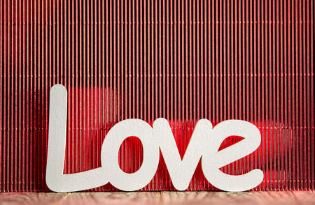 White love sign on wooden table and red backgroundの写真素材