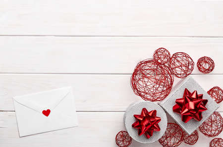 Composition of gifts and message on white wooden backgroundの写真素材