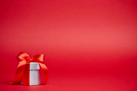 Red Christmas background with silver giftの写真素材