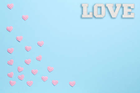 Plain blue background with love and little pink heartsの写真素材