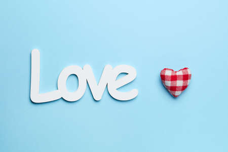 Plain blue background with red and white love heart signの写真素材