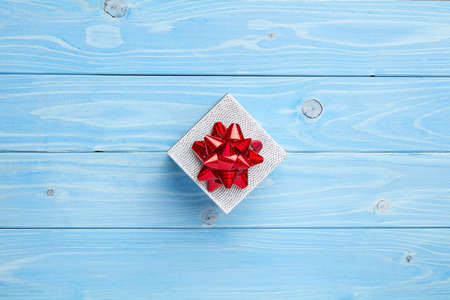 Composition of gift on blue wooden background