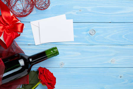 Wine and gift on blue wooden backgroundの写真素材