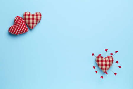 Plain blue background with three red heartsの写真素材