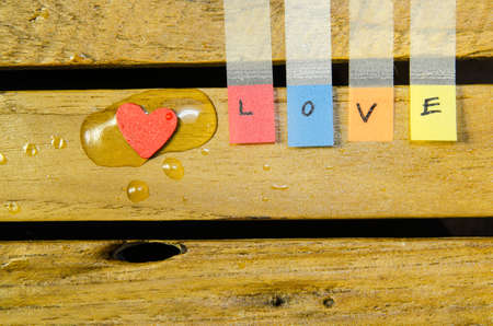 Red heart in water drop with love alphabetの写真素材