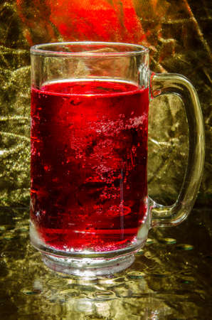 Abstract  red glass with gold backgroundの写真素材