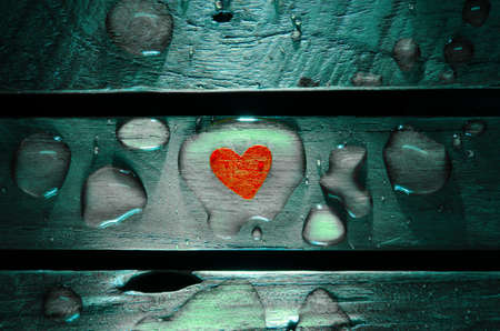 Red heart in water drop on wood pattern backgroundの写真素材