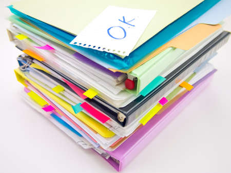 There is the huge pile of business documents on the desk.の写真素材