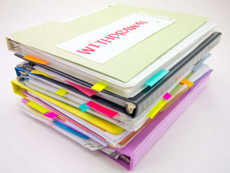 There is the huge pile of business documents on the desk.の写真素材