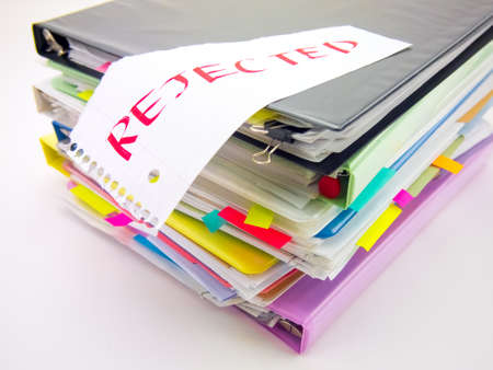 There is the huge pile of business documents on the desk.の写真素材