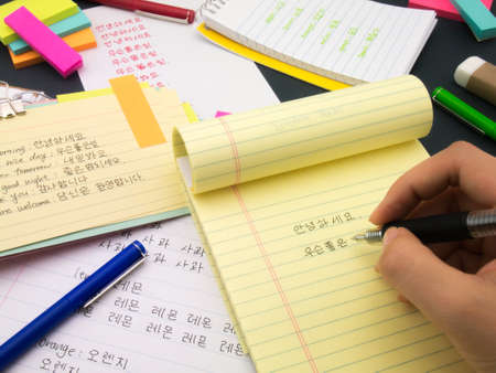 Writing new words again and again to learn new language.の写真素材