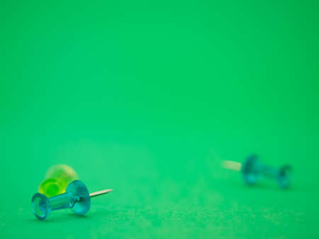 Allengement of colorful push pines on green background.の写真素材