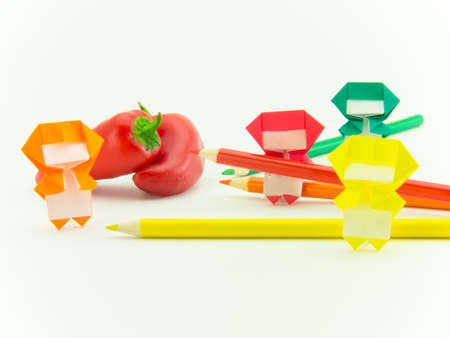 Colorful origami Ninja playing with the vegetables and fruits.の写真素材