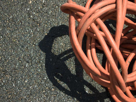 The Orange Extension Cord on the Ground at the Constructionsiteの写真素材