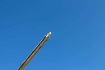 The Isolated Screwdriver with the Blue Sky Backgroundの写真素材