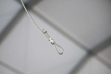 Cables and hook hanging from the Ceiling at the Construction siteの写真素材