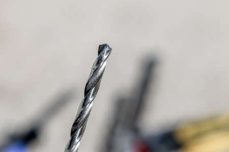 The Isolated Drill Bits with the Gray Ground Backgroundの写真素材