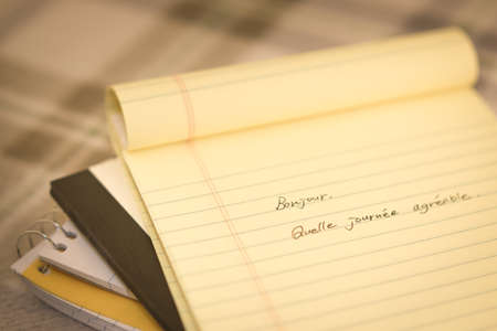 French; Learning New Language Writing Greetings on the Notebook (Translation; Good Morning)の写真素材
