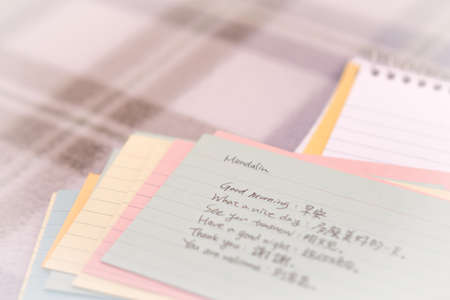 Mandarin; Learning New Language Writing Greetings on the Notebookの写真素材