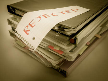 There is the huge pile of business documents on the desk.の写真素材