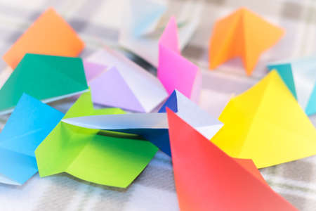 Randomly Scattered Small Origami Paper on the Tableの写真素材
