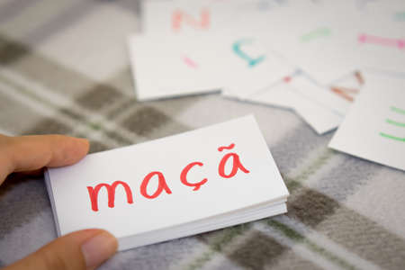 Portuguese; Learning the New Word with the Alphabet Cards (Translation; Apple)の写真素材