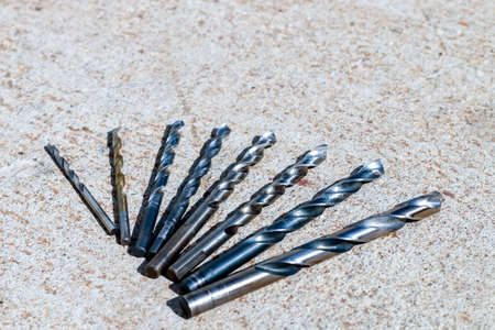 The Isolated Drill Bits with the Gray Ground Backgroundの写真素材
