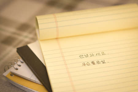 Korean; Learning New Language Writing Greetings on the Notebook (Translation; Good Morning)の写真素材