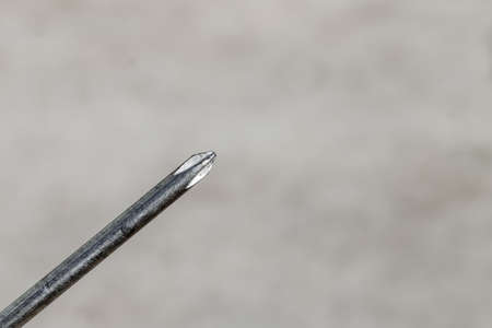 The Isolated Screwdriver with the Gray Ground Backgroundの写真素材