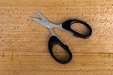 scissors with wood backgroundの写真素材