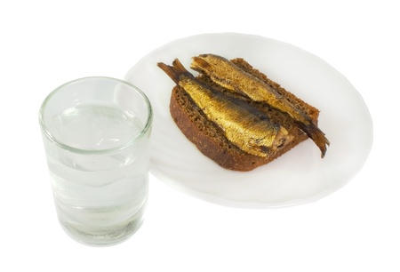Vodka and russian traditional appetizers - bread and fish isolated on white backgroundの写真素材