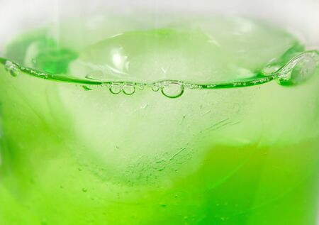 Closeup of green cocktail with ice cubesの写真素材