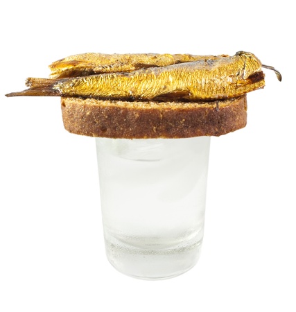 Vodka and russian traditional appetizers - bread and fish isolated on white backgroundの写真素材