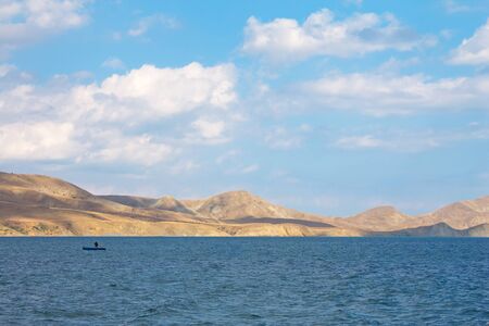 Black sea with boat and mountain on a horizon. Koktebel, Crimea, Ukraine.の写真素材