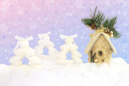 Firs and house on sparkle Christmas backgroundの写真素材