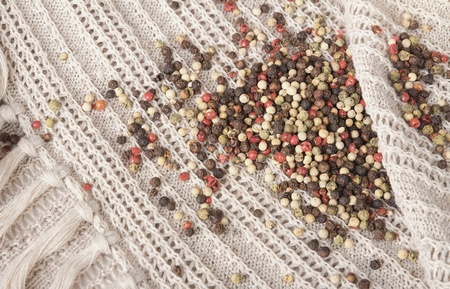 Colorful mixed peppercorns on a hessian background